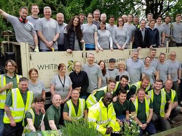 Group of Prologis team members in front of a sign on Impact Day