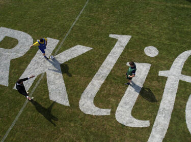 Two people playing football 